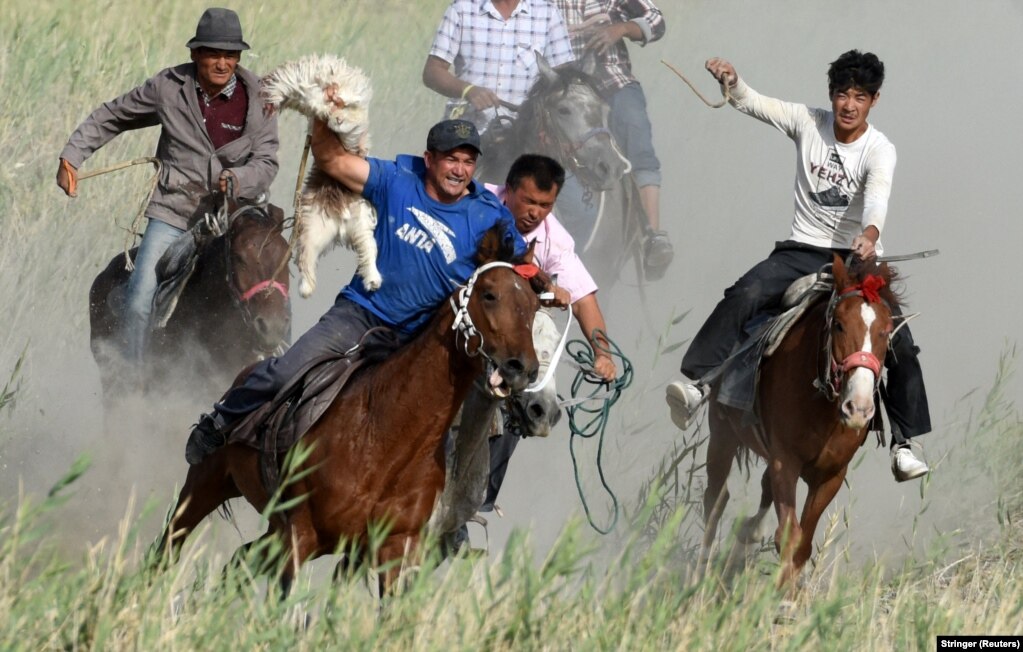 Participants ride horses as they compete for a goat carcass during a game of buzkashi in Bayingol, Xinjiang Uyghur Autonomous Region, China. (Reuters/Stringer)